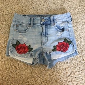 High waisted jean shorts with rose patches